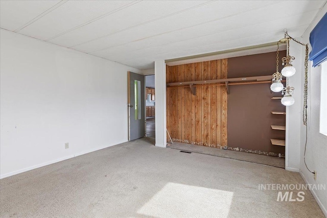 unfurnished bedroom with a closet, visible vents, baseboards, and carpet floors