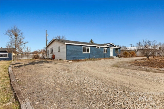 exterior space with driveway and fence