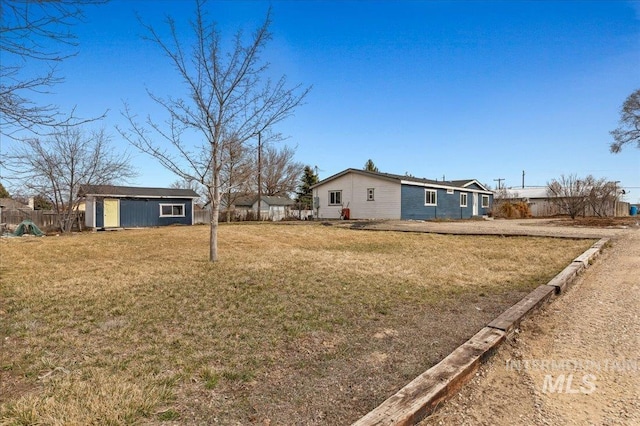 view of yard with an outbuilding and fence