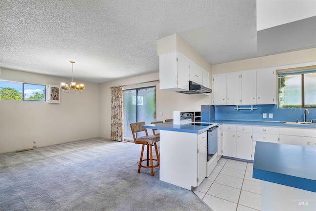 1332 Burrell Ave, Lewiston, ID 83501 - kitchen with a sink, plenty of natural light, a chandelier, white cabinetry, and a textured ceiling