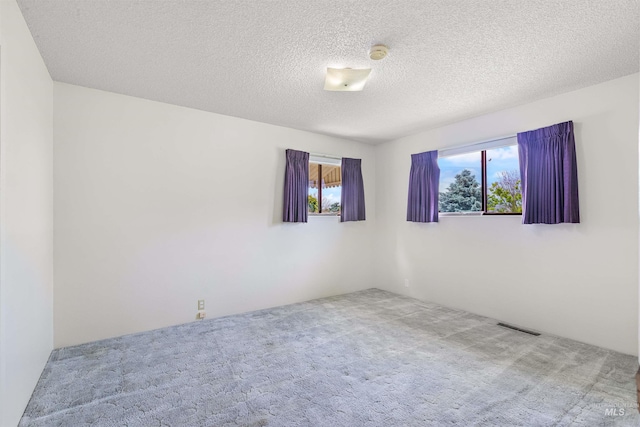 1332 Burrell Ave, Lewiston, ID 83501 - empty room featuring carpet floors, a smoke detector, and a textured ceiling