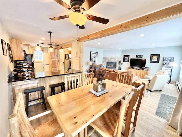 301 N Mission St Unit C3, Mccall, ID 83638 - dining area with a stone fireplace, light wood-style flooring, a ceiling fan, and recessed lighting