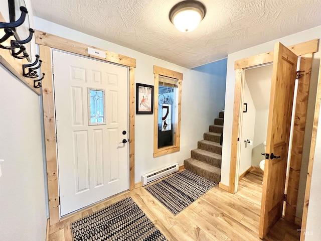 301 N Mission St Unit C3, Mccall, ID 83638 - entrance foyer featuring baseboard heating, light wood-type flooring, and stairway