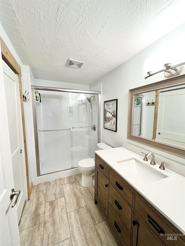 301 N Mission St Unit C3, Mccall, ID 83638 - full bath featuring vanity, a stall shower, and a textured ceiling