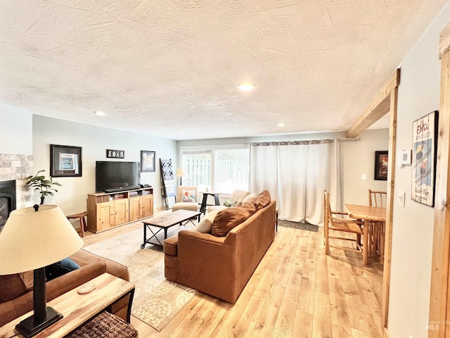301 N Mission St Unit C3, Mccall, ID 83638 - living room with a textured ceiling, light wood-style floors, a fireplace, and recessed lighting