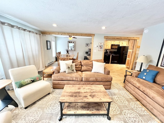 301 N Mission St Unit C3, Mccall, ID 83638 - living area with a baseboard heating unit, light wood-style flooring, recessed lighting, a ceiling fan, and a textured ceiling