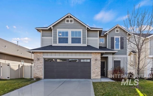 view of front of home with a front yard and a garage