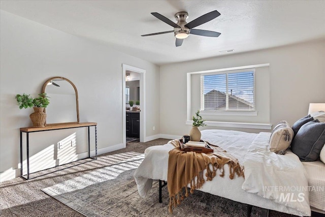 bedroom featuring ensuite bath, ceiling fan, and carpet