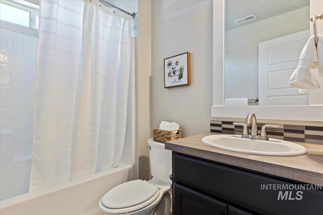 full bathroom with toilet, vanity, tasteful backsplash, and shower / bath combo with shower curtain