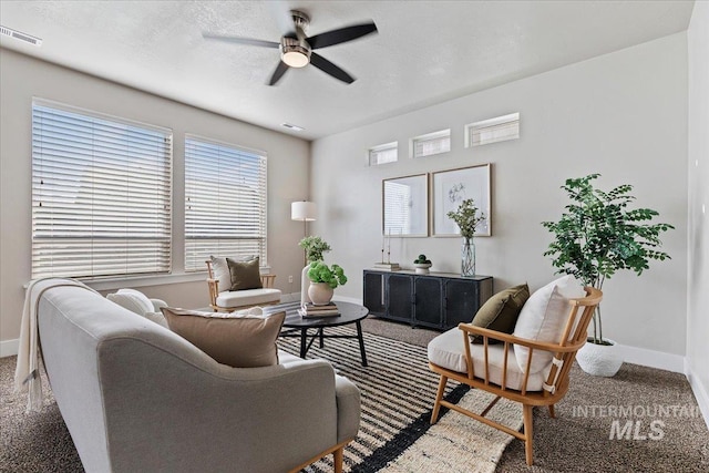 carpeted living room with ceiling fan