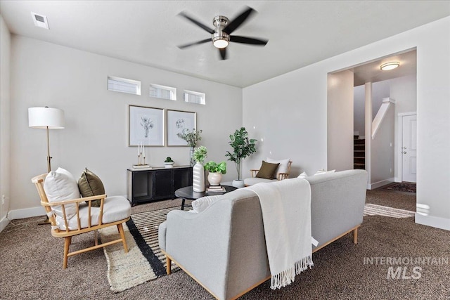 carpeted living room featuring ceiling fan