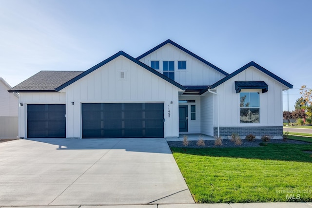 2122 N Thunderbolt St, Mountain Home, ID 83647 - modern farmhouse featuring a front yard, board and batten siding, driveway, and a garage
