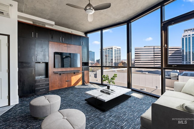 living room featuring expansive windows, ceiling fan, a healthy amount of sunlight, and dark carpet