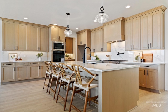 7760 W Flathead Lake St, Eagle, ID 83616 - kitchen featuring appliances with stainless steel finishes, recessed lighting, custom range hood, light countertops, and light wood finished floors