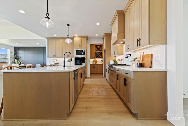 7760 W Flathead Lake St, Eagle, ID 83616 - kitchen with appliances with stainless steel finishes, light wood-type flooring, light countertops, recessed lighting, and an island with sink