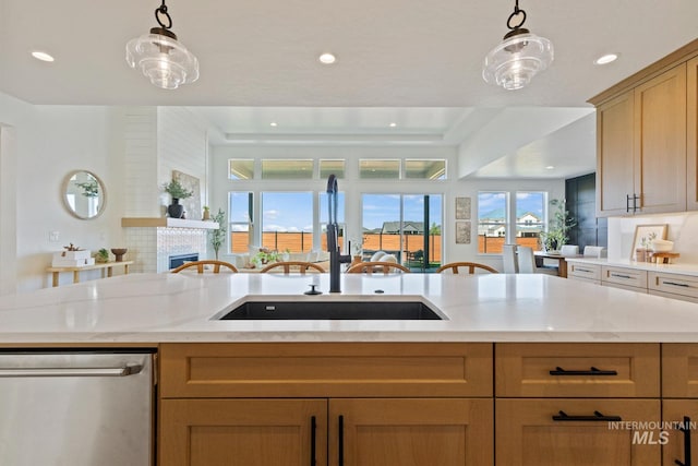 7760 W Flathead Lake St, Eagle, ID 83616 - kitchen with stainless steel dishwasher, open floor plan, decorative light fixtures, recessed lighting, and a glass covered fireplace