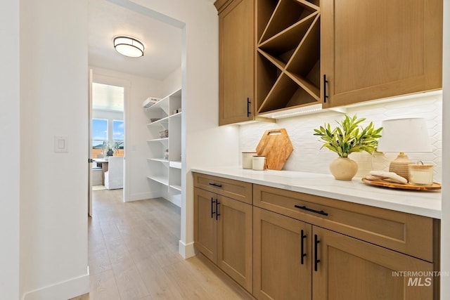 7760 W Flathead Lake St, Eagle, ID 83616 - bar area featuring tasteful backsplash and light wood-style flooring