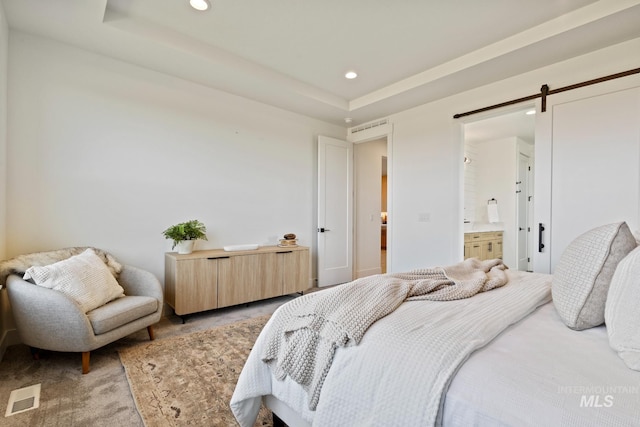 7760 W Flathead Lake St, Eagle, ID 83616 - bedroom with recessed lighting, a barn door, a raised ceiling, light colored carpet, and connected bathroom