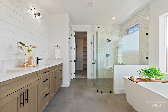 7760 W Flathead Lake St, Eagle, ID 83616 - full bath with a stall shower, a freestanding tub, double vanity, tile patterned floors, and a walk in closet