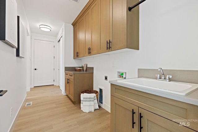 7760 W Flathead Lake St, Eagle, ID 83616 - laundry area featuring electric dryer hookup, cabinet space, washer hookup, and light wood-style floors