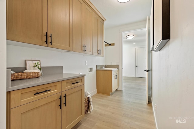 7760 W Flathead Lake St, Eagle, ID 83616 - kitchen featuring light wood-type flooring, light countertops, and light brown cabinets