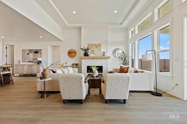 7760 W Flathead Lake St, Eagle, ID 83616 - living room with a towering ceiling, a tile fireplace, light wood-type flooring, and recessed lighting