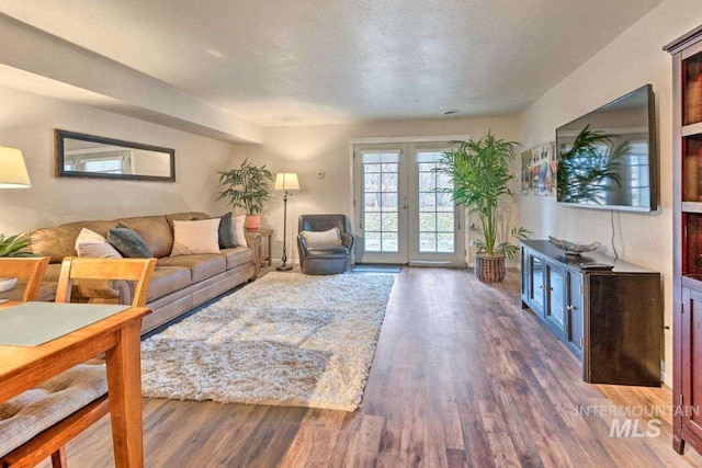 living room featuring dark hardwood / wood-style flooring and a textured ceiling