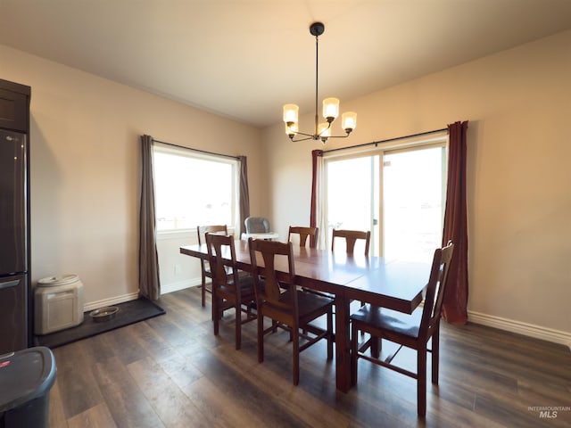 dining room featuring dark hardwood / wood-style floors and a notable chandelier
