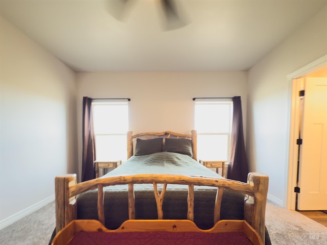 carpeted bedroom featuring ceiling fan and multiple windows