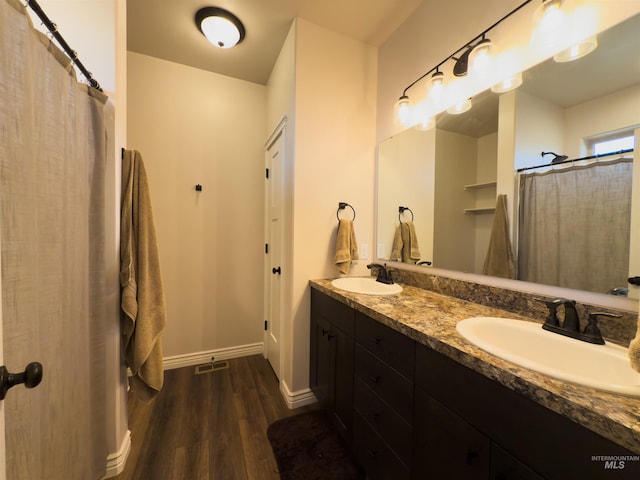bathroom featuring vanity, hardwood / wood-style floors, and walk in shower