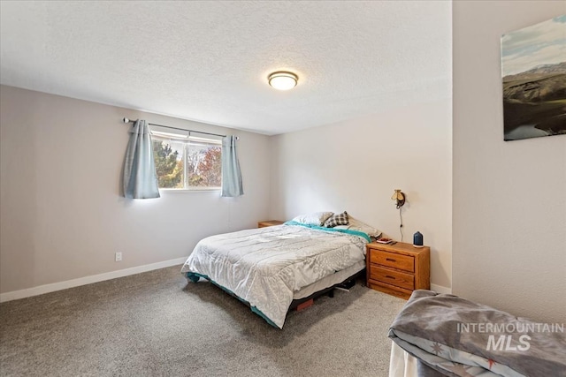 carpeted bedroom featuring a textured ceiling and baseboards