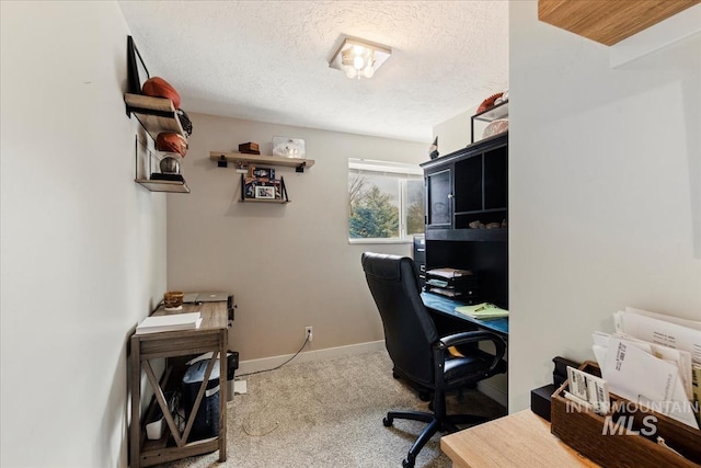 home office with a textured ceiling, carpet floors, and baseboards