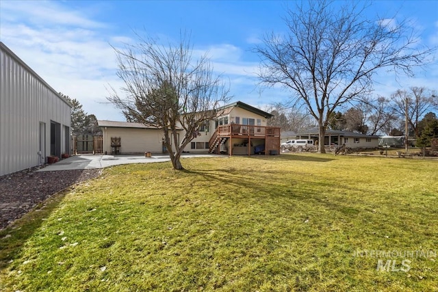 view of yard featuring a patio, stairway, and a wooden deck