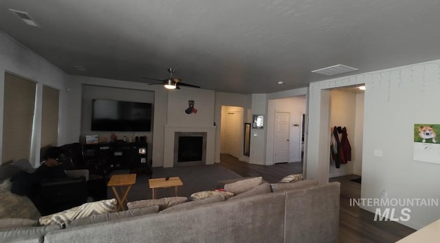 living room with dark hardwood / wood-style floors and ceiling fan