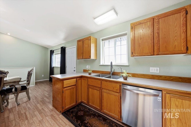 kitchen featuring kitchen peninsula, dishwasher, light hardwood / wood-style flooring, and sink