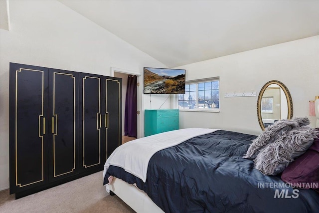 carpeted bedroom featuring vaulted ceiling