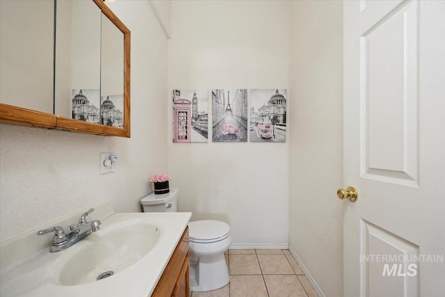 bathroom featuring vanity, tile patterned flooring, and toilet