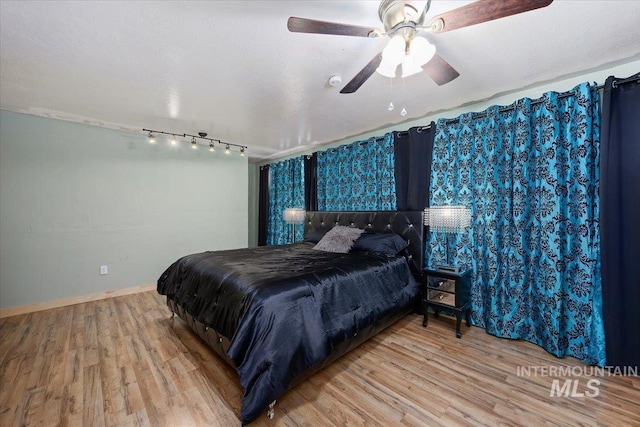 bedroom with ceiling fan and hardwood / wood-style floors