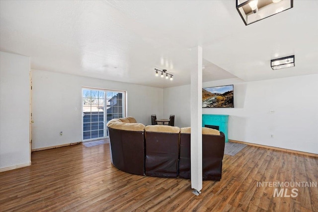 living room featuring hardwood / wood-style flooring and track lighting