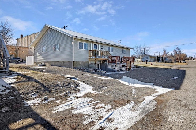 back of property featuring a wooden deck