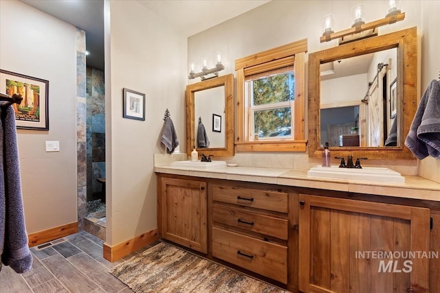 bathroom featuring walk in shower and vanity