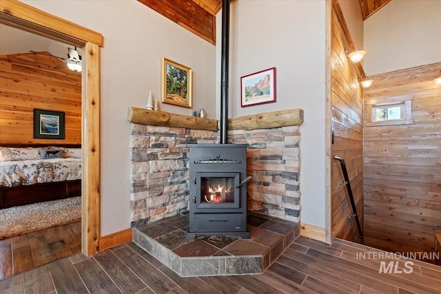 details featuring a wood stove and wood walls