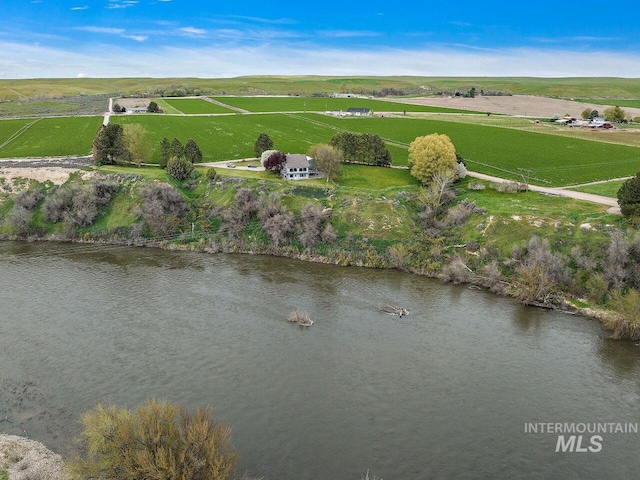 birds eye view of property with a rural view and a water view