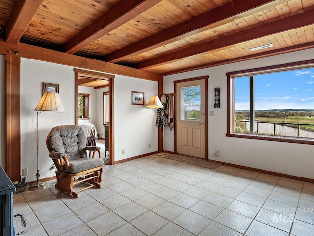 unfurnished room featuring wood ceiling, beam ceiling, and light tile floors