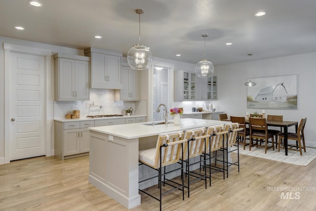 12039 N 19th Ave, Boise, ID 83714 - kitchen featuring gas cooktop, light wood-style floors, light countertops, decorative backsplash, and recessed lighting