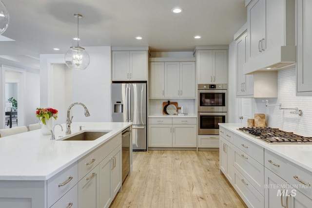 12039 N 19th Ave, Boise, ID 83714 - kitchen featuring stainless steel appliances, light countertops, backsplash, recessed lighting, and light wood-type flooring