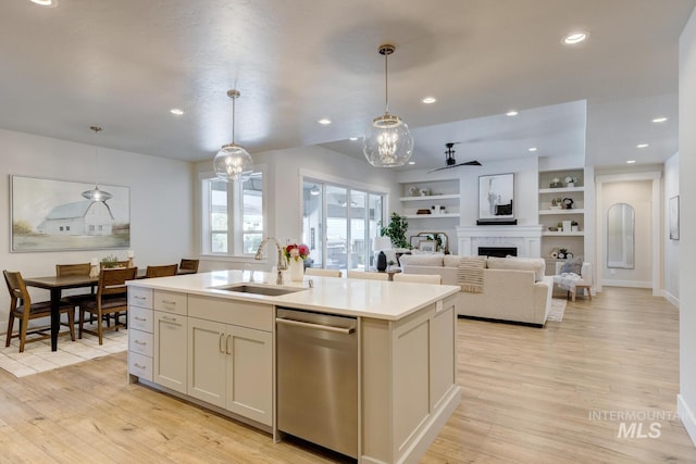 12039 N 19th Ave, Boise, ID 83714 - kitchen featuring dishwasher, light wood finished floors, a kitchen island with sink, decorative light fixtures, and recessed lighting