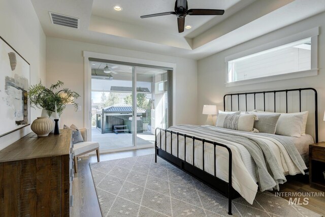 12039 N 19th Ave, Boise, ID 83714 - bedroom with access to outside, wood finished floors, a raised ceiling, recessed lighting, and a ceiling fan