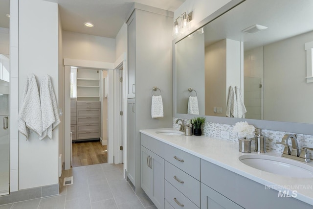 12039 N 19th Ave, Boise, ID 83714 - full bath featuring double vanity, a shower stall, tile patterned floors, and a walk in closet