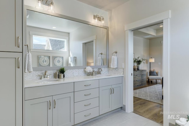 12039 N 19th Ave, Boise, ID 83714 - ensuite bathroom featuring double vanity, backsplash, and tile patterned floors